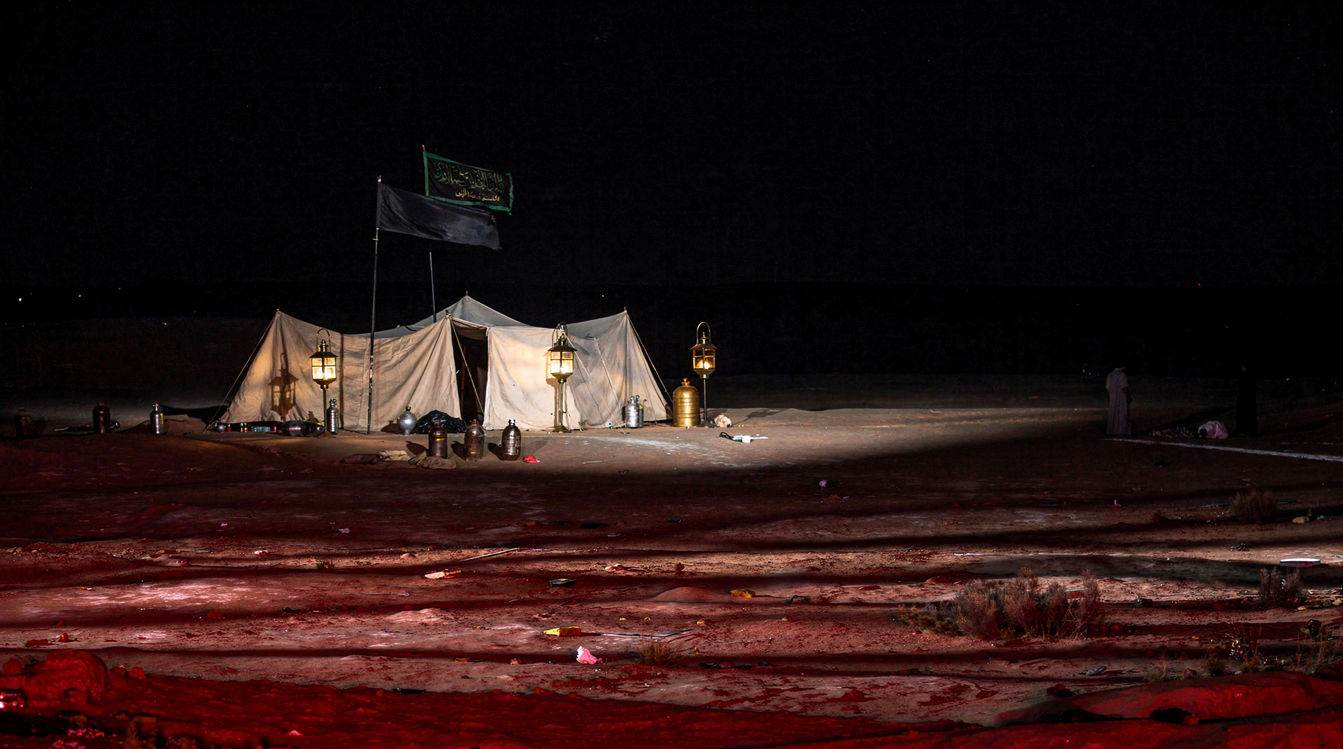 A quiet camp lit by lanterns